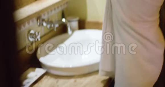 女人在浴室里放松女人穿着毛巾放松放松的女人看着镜子视频的预览图
