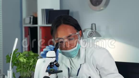 一位黑人女科学家的特写镜头对显微镜下的实验结果感到惊讶视频的预览图