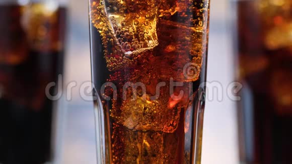 用可乐和冰块把杯子里的泡泡封闭起来汽水冒出气泡视频的预览图