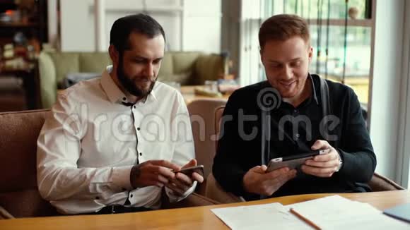 两位商人讨论平板电脑和手机项目的肖像视频的预览图