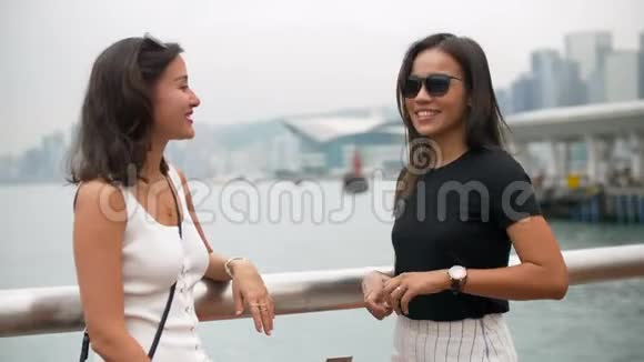 美丽的年轻亚洲女人戴上唇膏听着朋友的笑声视频的预览图