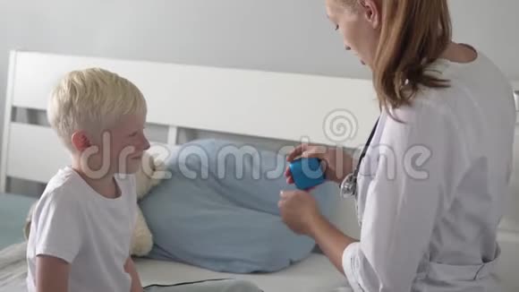 医生给医院里的一个男孩吃药视频的预览图