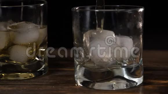 黄金麦芽威士忌倒入一个玻璃玻璃与冰块视频的预览图