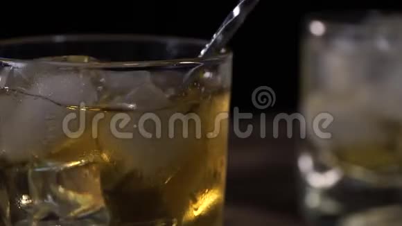 酒保在木条柜台上用勺子搅拌冰块视频的预览图