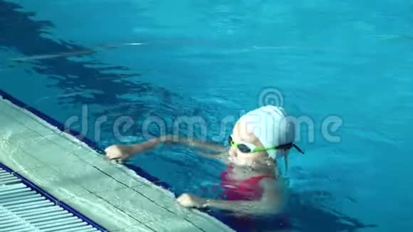 在泳池外靠近高加索女游泳选手女子完成游泳比赛视频的预览图
