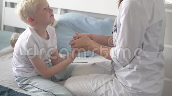 医生看着医院里一个生病的男孩视频的预览图