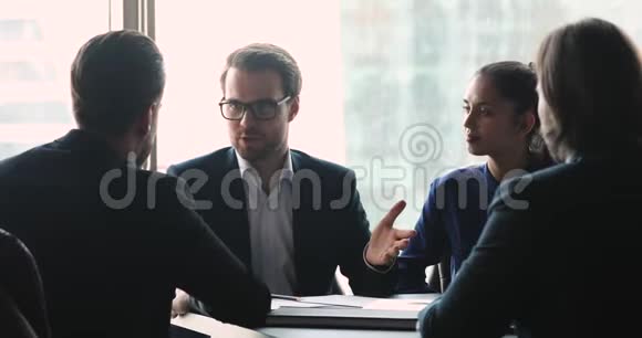 快乐的男性伙伴在董事会会议桌上握手视频的预览图