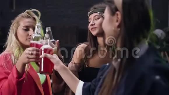 在夏季晚上的聚会上一群快乐的年轻女性朋友一起在一起喝啤酒和碰杯视频的预览图