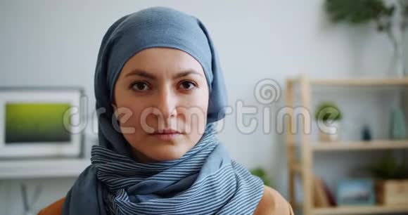 戴着头巾微笑着看镜头的穆斯林美女的特写照片视频的预览图