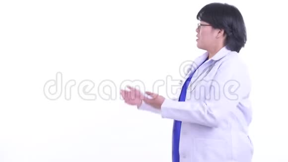 快乐超重的亚洲女医生在背后讲话视频的预览图