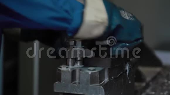金属加工数控铣床在工厂生产金属细节戴蓝色手套的工人把工件固定在视频的预览图