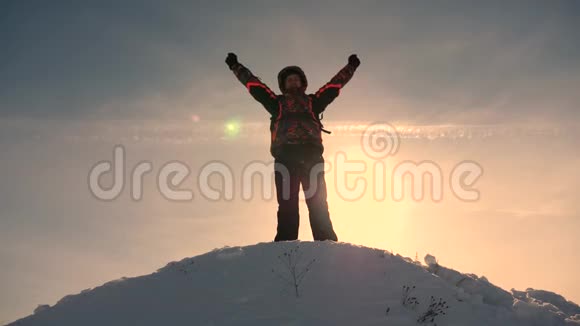 阿拉斯加的旅行者来到一座雪山的山顶为战胜冬日的日落而欢欣鼓舞登山者之旅视频的预览图