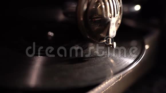 破旧的留声机打开了针放在旋转盘上黑色的黑暗背景视频的预览图