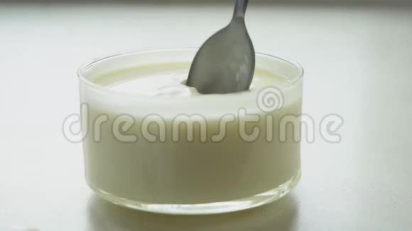 把酸奶和勺子混合在杯子里视频的预览图