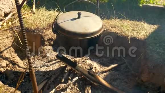 一顶在火堆上的礼帽在野餐时做饭徒步旅行夏日视频的预览图