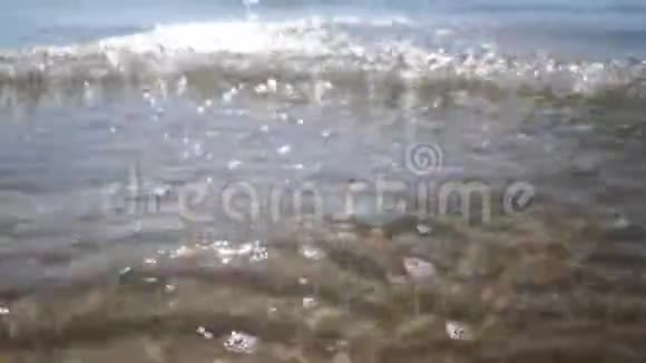 用鹅卵石把海滩上的海浪拉近软焦视频的预览图