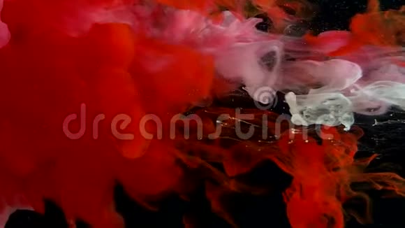 红色和白色水彩墨水在水中的黑色背景上彩色太空魔法背景视频的预览图