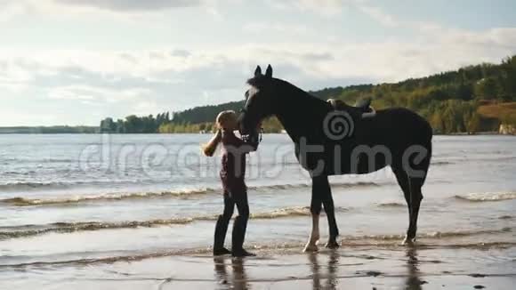 在海滩上照顾马的女孩视频的预览图