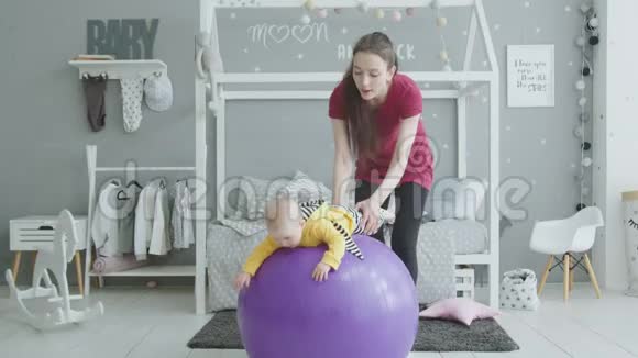 快乐妈妈在室内训练女婴视频的预览图