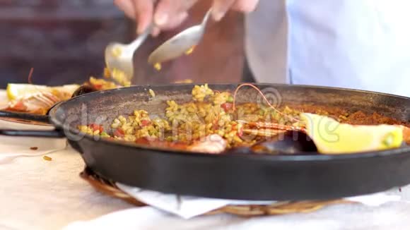 一名服务员在西班牙餐厅供应传统的地中海海鲜饭视频的预览图