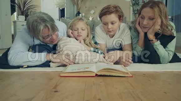祖父母和他们的孙辈一起读一本书视频的预览图