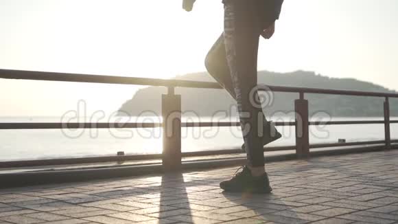 日落时做伸展运动的女孩慢动作视频的预览图