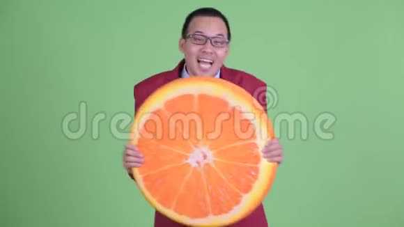 快乐的亚洲商人戴着眼镜抱着橙色的枕头作为健康的概念视频的预览图