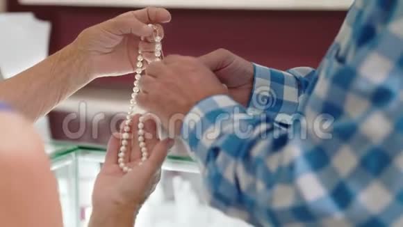 快乐的老夫妇在商店买珍珠项链视频的预览图