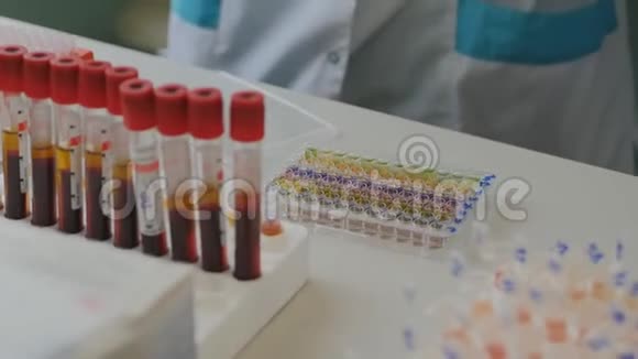实验室里的一位生物学家用试管关上了盒子的盖子里面倒着病毒疫苗的样品视频的预览图