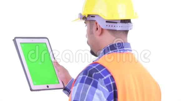 使用数码平板电脑的留胡子波斯人建筑工人的近距离后视镜视频的预览图