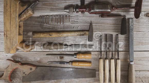 老式木工工具手钻凿子锯子平面锉刀和螺丝移动并留下标识或文字的开口视频的预览图