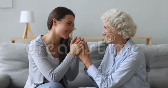 有爱心的年轻女子孙女牵着老奶奶的手说着话视频的预览图