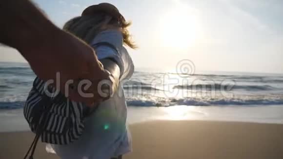 跟着我拍的女人带着背包在日落时带着她的男朋友在海边穿着沙滩服装的女孩视频的预览图