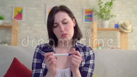 沮丧的年轻悲伤的女人手里拿着一个关于怀孕定义的阴性测试视频的预览图
