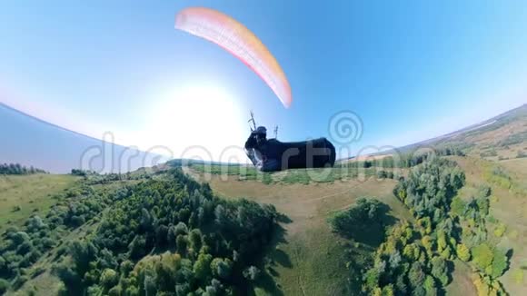 一个人正带着一个公羊空降落伞在田野上空飞行人滑翔伞美丽的自然背景视频的预览图