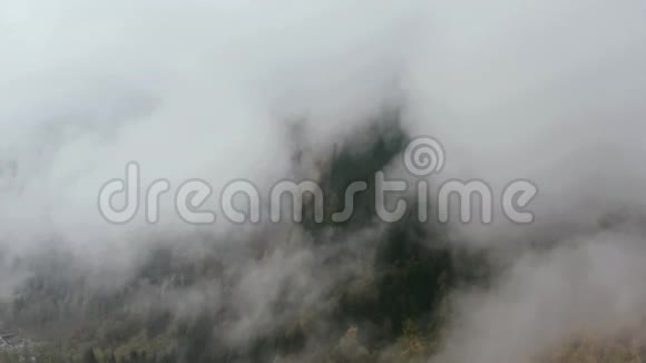 无人机飞过秋雾云雾翻山越岭向着村庄和峡湾飞去视频的预览图