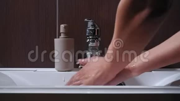 卫生理念一个男人在浴室里洗手特写男人用肥皂和水在水龙头下洗手视频的预览图