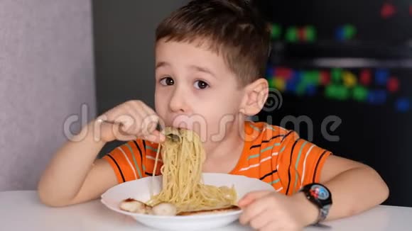 孩子们在餐桌上玩意大利面糟糕的脸吃东西酱汁和孩子男孩坐在托儿所吃面条视频的预览图