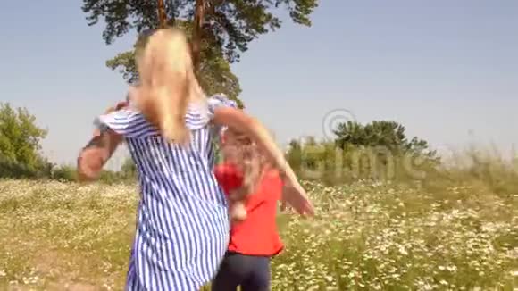 快乐情侣女孩跑花草甸后景视频的预览图