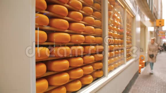 奶酪店橱窗边的女人阿姆斯特丹的首都有很多排圆形的奶酪头视频的预览图