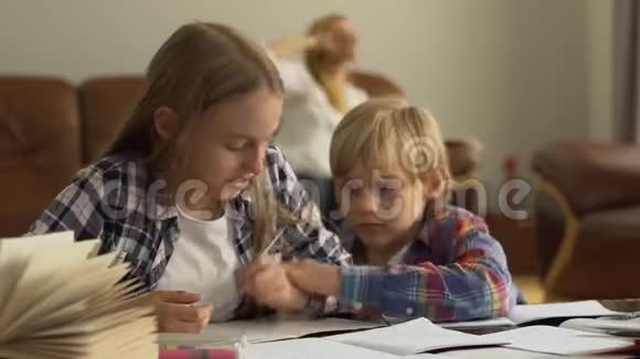 可爱的弟弟妹妹在家学习孩子们一起做作业男孩阻止女孩视频的预览图