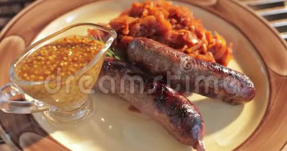带有泡菜和芥末酱的烤香肠放在盘子餐具叉子刀和餐巾纸上视频的预览图