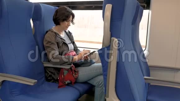 女人坐在火车上手里拿着手机咔嚓咔嚓的侧视视频的预览图