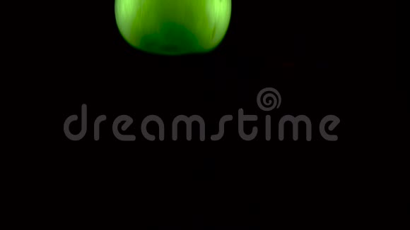 绿苹果在水中缓慢地落下与阿尔法隔离在黑色背景上近景视频的预览图