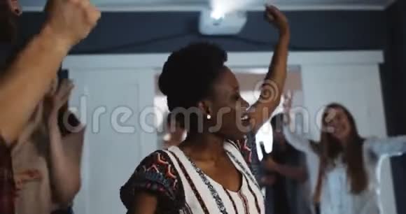 快乐的年轻非洲女学生有史诗般的乐趣与大学朋友跳舞在五彩纸屑生日聚会慢动作视频的预览图