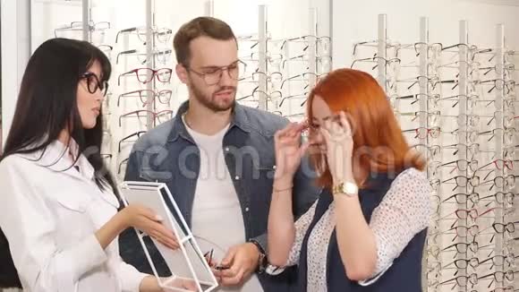 红发客户戴上现代化的眼镜看着镜子视频的预览图