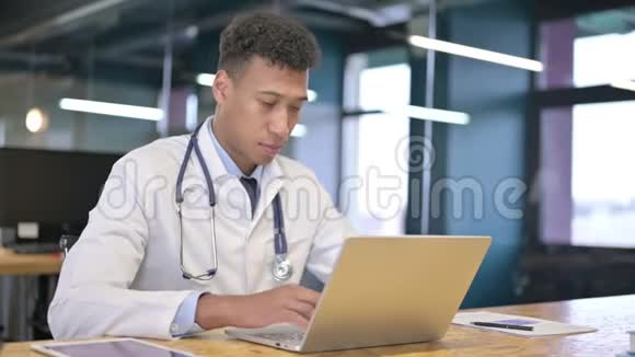 年轻医生思考与办公室笔记本电脑工作视频的预览图