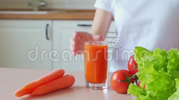 女人在杯子里喝胡萝卜汁视频的预览图