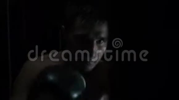 特写镜头拳击手在地下健身房的摄像机上直接击球视频的预览图