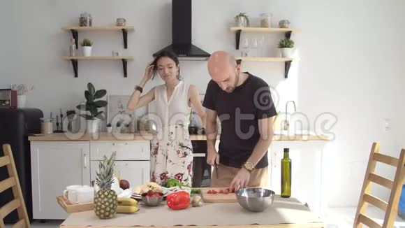厨房里的幸福夫妻有趣的年轻夫妇一起做饭很开心视频的预览图